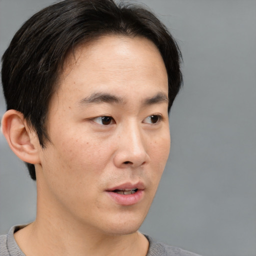 Neutral asian adult male with short  brown hair and brown eyes