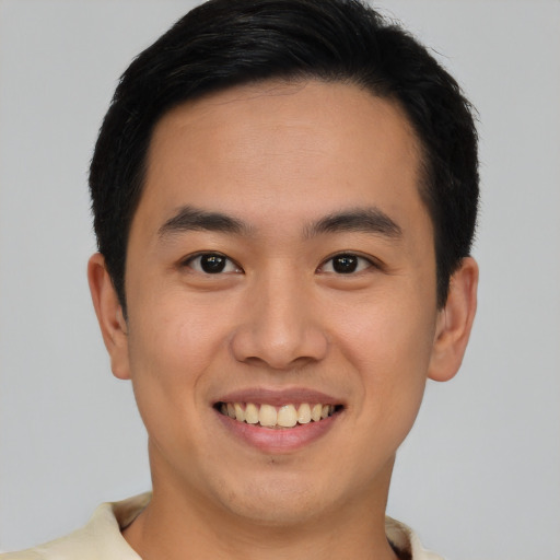 Joyful latino young-adult male with short  brown hair and brown eyes