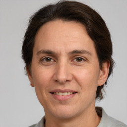 Joyful white adult male with medium  brown hair and brown eyes