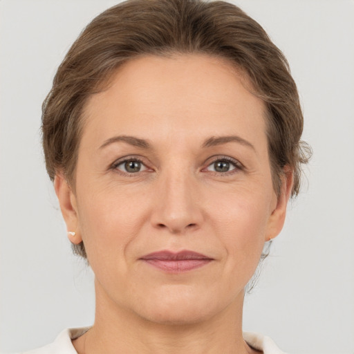 Joyful white adult female with short  brown hair and brown eyes