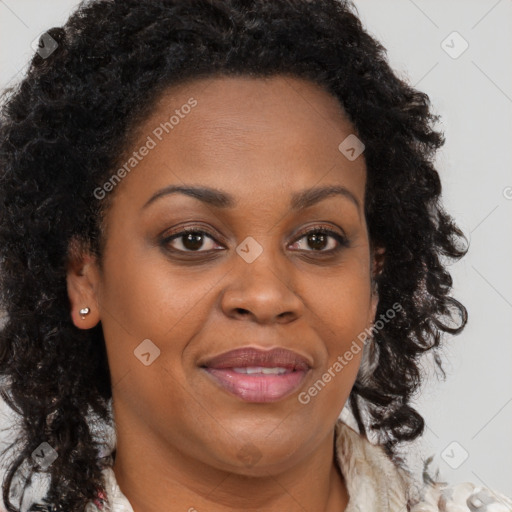 Joyful black adult female with long  brown hair and brown eyes