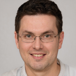 Joyful white adult male with short  brown hair and brown eyes