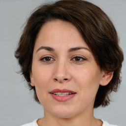 Joyful white adult female with medium  brown hair and brown eyes