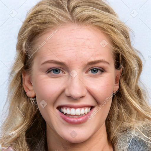 Joyful white young-adult female with long  brown hair and blue eyes