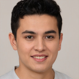 Joyful latino young-adult male with short  brown hair and brown eyes