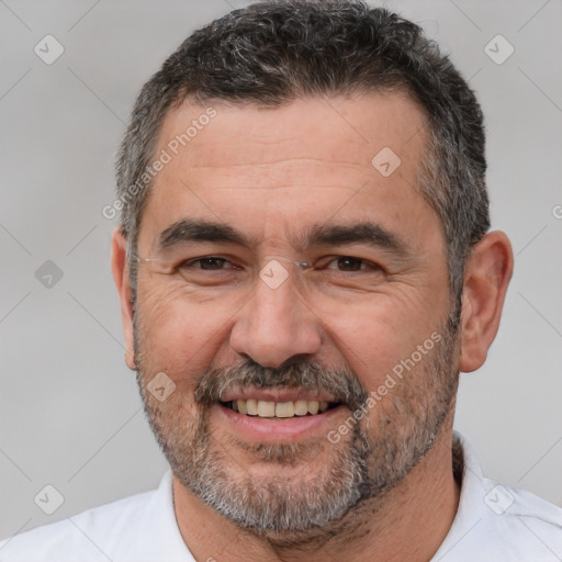 Joyful white adult male with short  brown hair and brown eyes