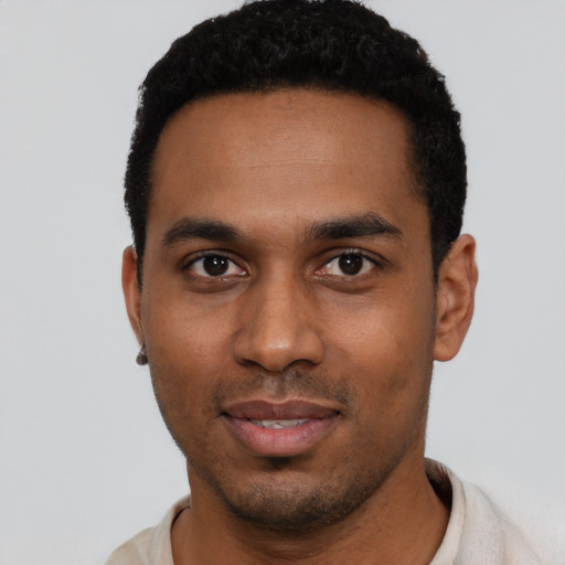 Joyful black young-adult male with short  black hair and brown eyes