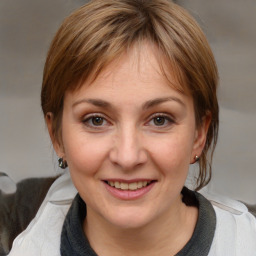 Joyful white adult female with medium  brown hair and brown eyes