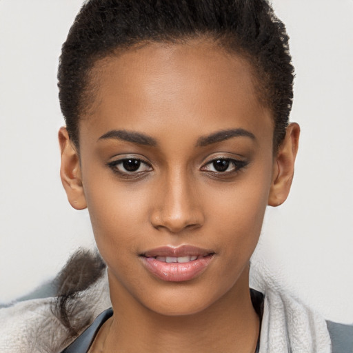 Joyful black young-adult female with short  brown hair and brown eyes