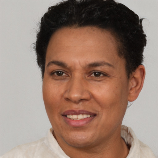 Joyful latino adult female with short  brown hair and brown eyes