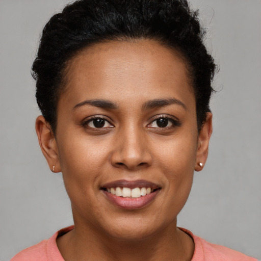 Joyful latino young-adult female with short  brown hair and brown eyes