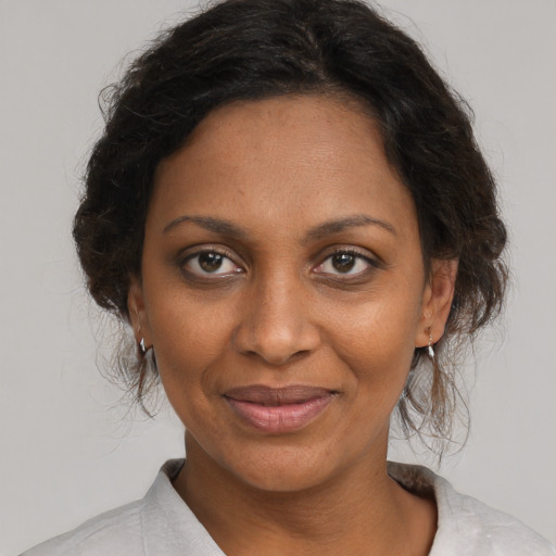 Joyful black young-adult female with medium  brown hair and brown eyes