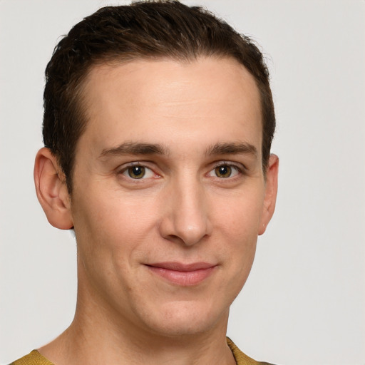 Joyful white young-adult male with short  brown hair and grey eyes