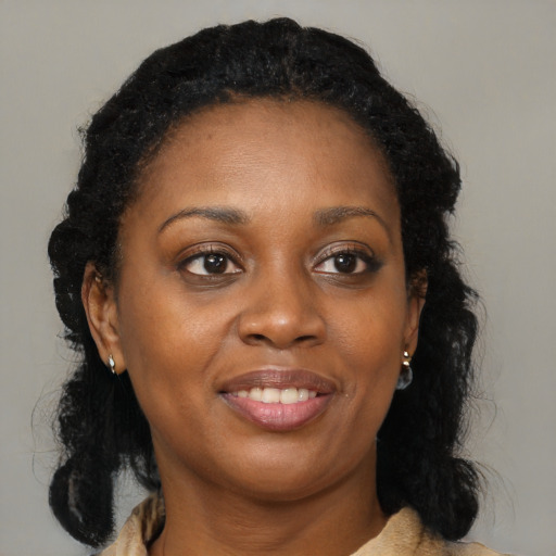 Joyful black young-adult female with medium  brown hair and brown eyes