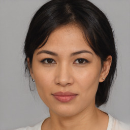 Joyful asian young-adult female with medium  brown hair and brown eyes