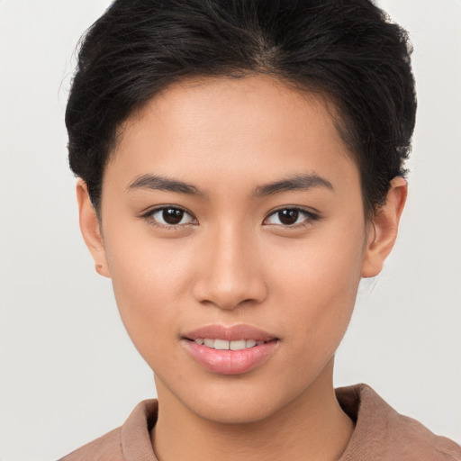 Joyful asian young-adult female with short  brown hair and brown eyes