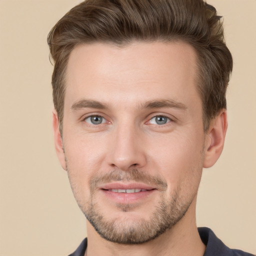 Joyful white young-adult male with short  brown hair and grey eyes