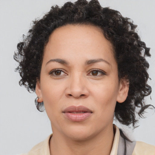 Joyful black young-adult female with medium  brown hair and brown eyes