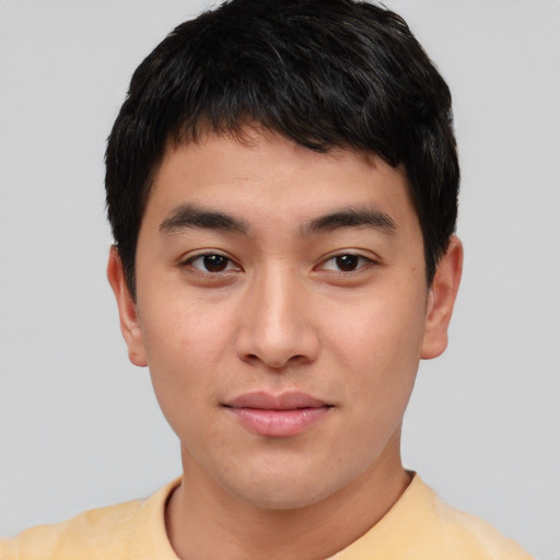 Joyful asian young-adult male with short  black hair and brown eyes
