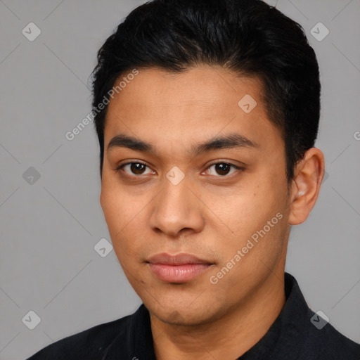 Joyful latino young-adult male with short  black hair and brown eyes