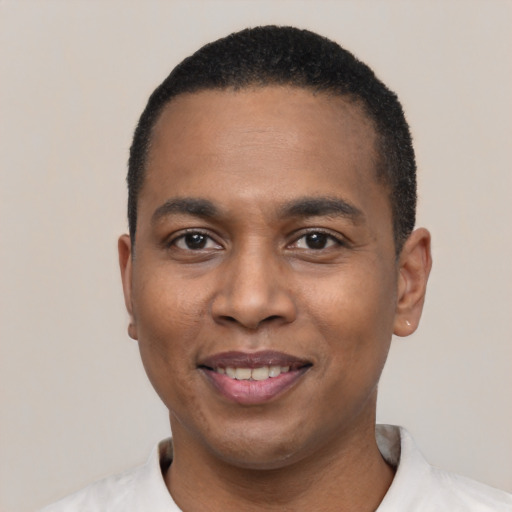 Joyful black young-adult male with short  black hair and brown eyes