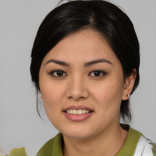 Joyful asian young-adult female with medium  black hair and brown eyes