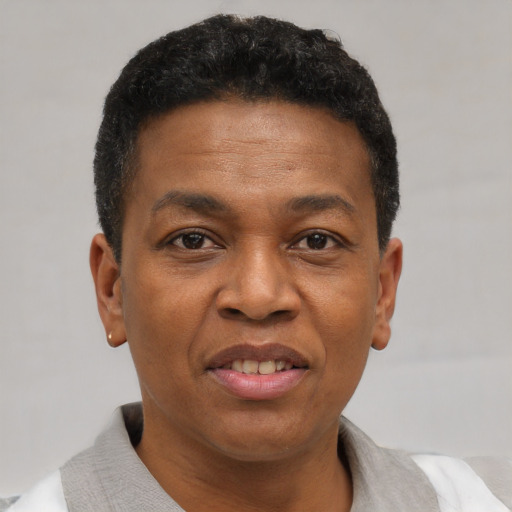 Joyful black adult male with short  brown hair and brown eyes