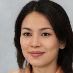 Joyful asian young-adult female with long  brown hair and brown eyes