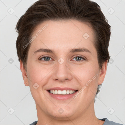 Joyful white young-adult female with short  brown hair and grey eyes