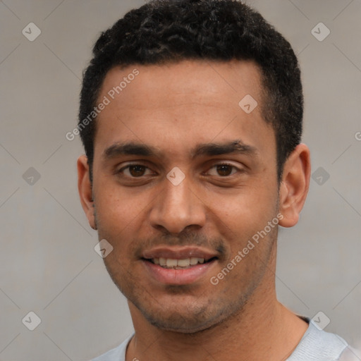 Joyful white young-adult male with short  black hair and brown eyes