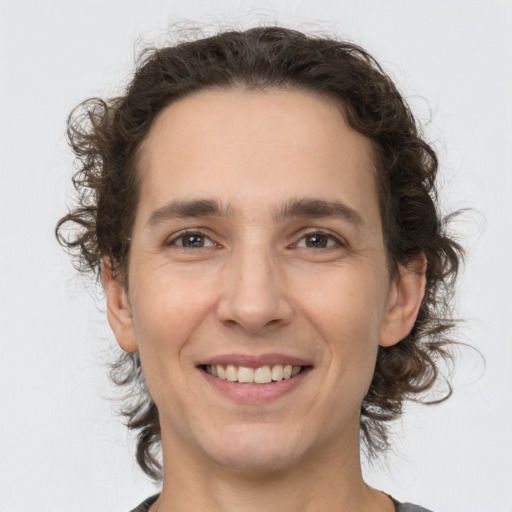 Joyful white young-adult male with medium  brown hair and brown eyes