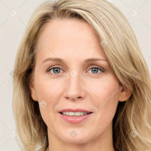 Joyful white adult female with medium  brown hair and blue eyes