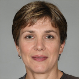 Joyful white adult female with medium  brown hair and grey eyes