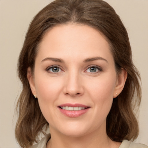 Joyful white young-adult female with medium  brown hair and grey eyes