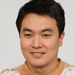 Joyful asian young-adult male with short  brown hair and brown eyes