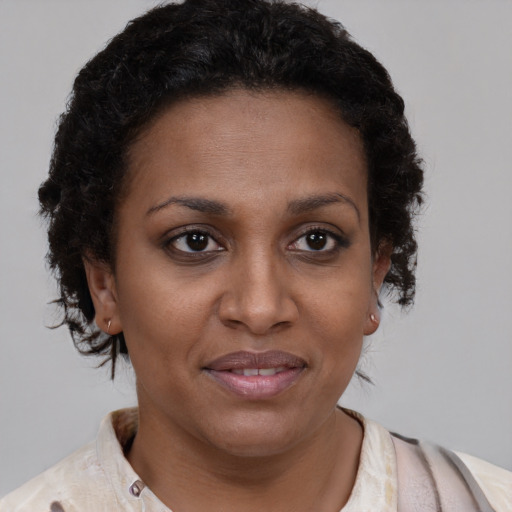 Joyful latino adult female with short  brown hair and brown eyes