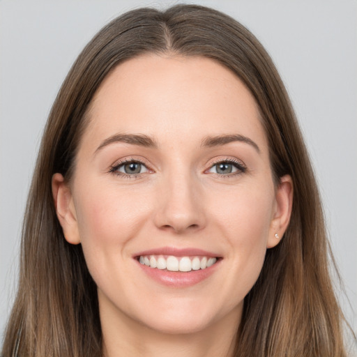 Joyful white young-adult female with long  brown hair and grey eyes