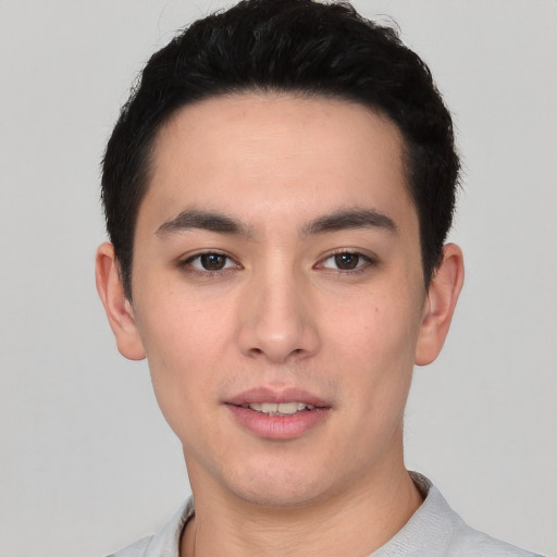 Joyful white young-adult male with short  black hair and brown eyes