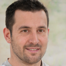 Joyful white adult male with short  brown hair and brown eyes