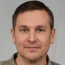 Joyful white adult male with short  brown hair and grey eyes