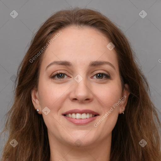 Joyful white adult female with long  brown hair and grey eyes