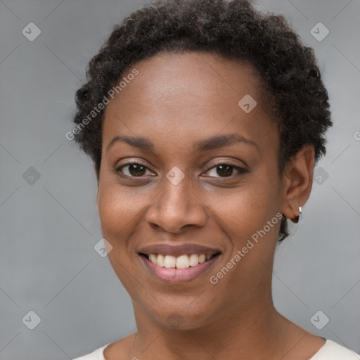 Joyful black young-adult female with short  brown hair and brown eyes