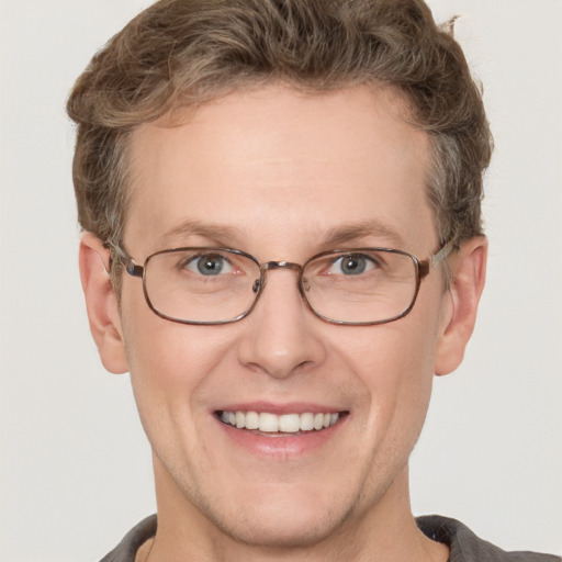 Joyful white adult male with short  brown hair and grey eyes