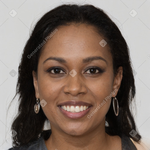 Joyful black young-adult female with long  brown hair and brown eyes