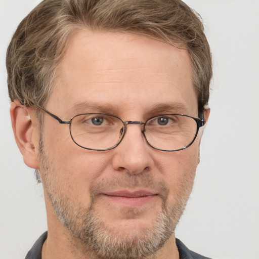 Joyful white adult male with short  brown hair and grey eyes