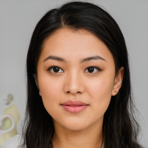 Joyful asian young-adult female with long  brown hair and brown eyes