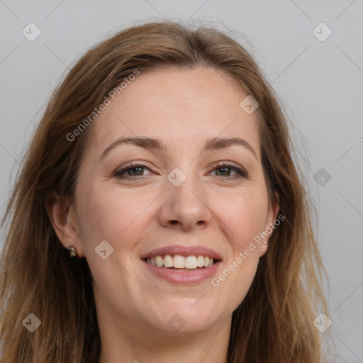 Joyful white adult female with long  brown hair and grey eyes