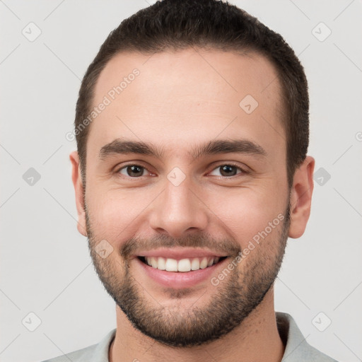 Joyful white young-adult male with short  brown hair and brown eyes