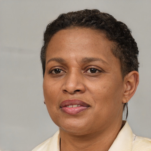 Joyful black adult female with short  brown hair and brown eyes