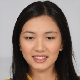 Joyful asian young-adult female with long  brown hair and brown eyes